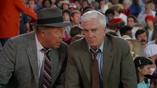 Things get serious in the finale as Capt. Hocken (George Kennedy) and Lt. Drebin (Leslie Nielsen) try to stop a royal assassination attempt at Anaheim Stadium.