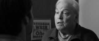 Former business partner and local karaoke singer Ed Pegram (Stacy Keach) lays claim to some of Woody's earnings while confronting David in the bathroom.