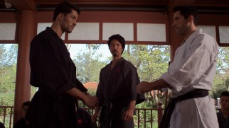 Casey (Scott Adkins) prepares to spar with a senior student (Jawed El Berni) at the Thai dojo of his 'senpai' Nakabara (Kane Kosugi).