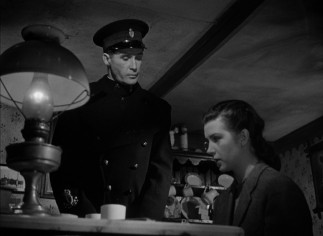 Johnny's girl Kathleen Sullivan (Kathleen Ryan) is unshaken by an inspector's snooping and questioning.