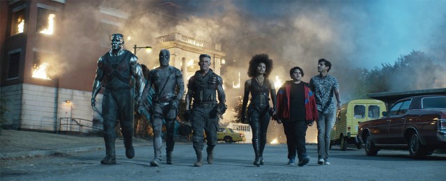 Colossus, Deadpool (Ryan Reynolds), Cable (Josh Brolin), Domino (Zazie Beetz), Firefist (Julian Dennison), and Dopinder (Karan Soni) walk heroically away from their big action climax.