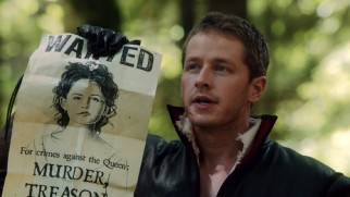 In a fairy tale sequence, Prince Charming (Josh Dallas) holds up the Wanted poster calling for Snow White's arrest.