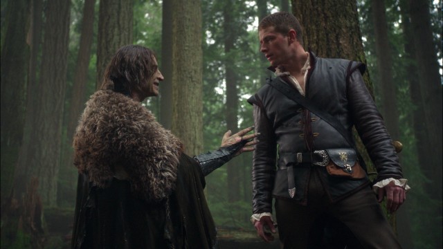 Rumplestiltskin (Robert Carlyle) and Prince Charming (Josh Dallas) make a deal in the woods of fairy tale land.