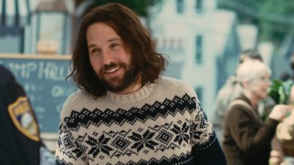 Ned Rochlin (Paul Rudd) dons a sweater and a smile in front of the police officer who is about to lead to jail time.