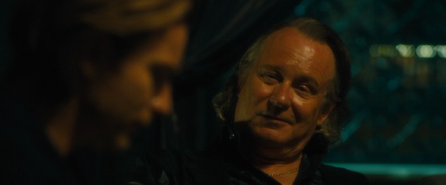 Dima (Stellan Skarsgrd) seduces Perry into a friendship by memorizing his credit card number after one glance.