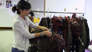 Costume designer Katia Stano shows off some of the Grounders' distinct wardrobe offerings.
