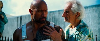 The reformed Paul Doyle (Dwayne Johnson) has his patience tested by the handsy Pastor Randy (Larry Hankin).