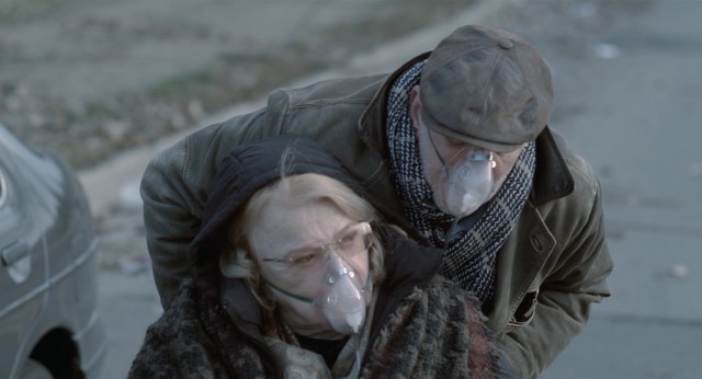 Wealthy older couple Esther (Gena Rowlands) and Andrew Sachs (Frank Langella) protect themselves with oxygen tanks and respiratory masks.