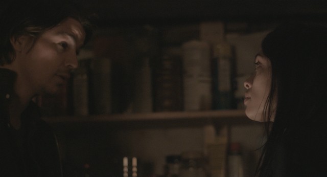 Len (Josh Hartnett) and Mia (Rosario Dawson) consider their options while taking safety in a sealed-off basement.