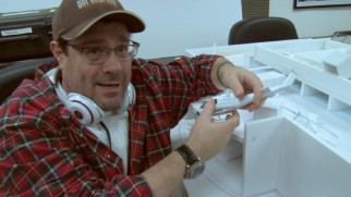 Director Andy Fickman shows off plans for an action sequence in miniature model form.