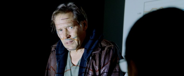 In "Persecuted", fugitive evangelist John Luther (James Remar) crashes the darkened room where the board he used to chair meets and has quarterly figures projected onto his body.