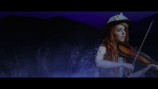 Lindsey Stirling fiddles under the stars in the "Something Wild" music video.
