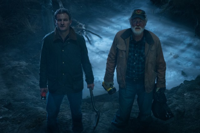 Louis Creed (Jason Clarke) and next door neighbor Jud Crandall (John Lithgow) bury the Creed family's deceased cat in a remote corner of "Pet Sematary."