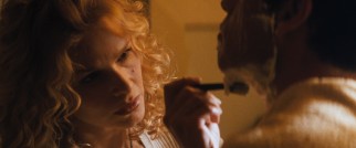 Independent chairmaker Lace (Kyra Sedgwick) gives George a romantic shave.