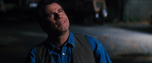 37-year-old George Malley (John Travolta) sees bright lights in the sky approaching Earth. What does it mean? Phenomenon! Do-doo-do-do-doo.