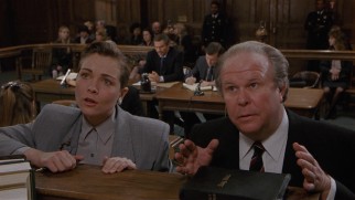 Dueling lawyers (Theresa Russell and Ned Beatty) approach the bench.