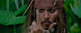 Captain Jack (Johnny Depp) pays notice to a drop of water falling up his finger.