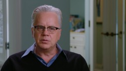 A white-haired Tim Robbins looks back at "The Player" in "Planned Improvisation."