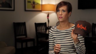 Kristen Wiig shows off the Portlandia cap in which she claims she was paid for her Season 2 guest appearance.