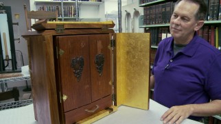 Jason Haxton proudly showcases the Dibbuk Box he owns in a documentary that claims, as a safety precaution, it filmed an exact replica of the real haunted wine cabinet.