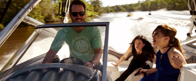 Jack (Mark-Paul Gosselaar) navigates a speedboat to dodge armed criminals on jet skis and in boats in "Precious Cargo."