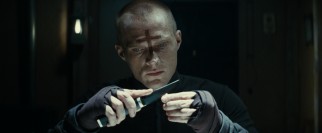 Our unnamed protagonist priest (Paul Bettany) prepares for vampire slaying by etching crosses into bullets.
