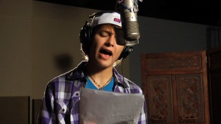 Nolan Sotillo consults the lyrics to the Spanish version of his end credits song, "Juntos Lo Haremos Bien", translating roughly to "We Go Together Well."