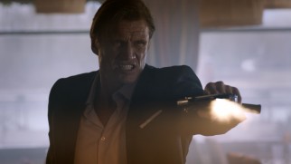 Though his fists are weapons of mass destruction, Dolph Lundgren saves some time and effort with a machine gun.