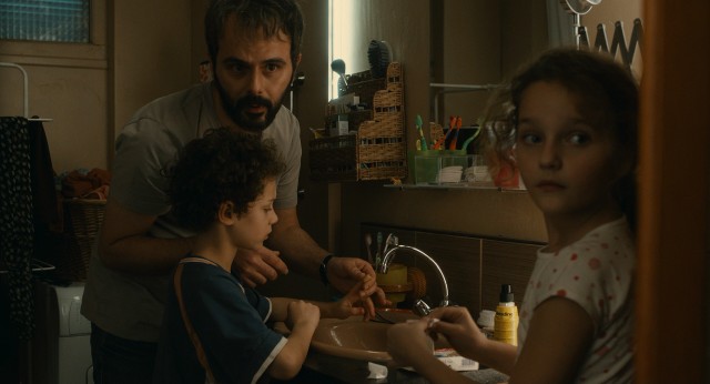 Ahmad (Ali Mosaffa) cleans a cut finger of his ex-wife's lover's son in "The Past."