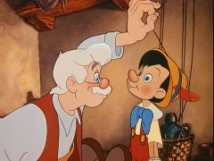 Geppetto pulls the strings to make his wooden puppet look up at him