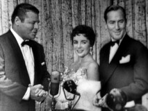 Elizabeth Taylor and her second husband Michael Wilding convey excitement and admiration to brisk interviewer Jack Carson in the Pantages Premiere TV special.