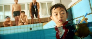 Raymond looks at the tiny snorkeler he deems responsible for their unplanned, fully-clothed trip into the school pool.