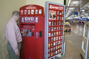 A businessman might choose to rent from a Redbox machine inside a Wal-Mart.