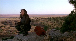 Against the scenic Calumet landscape, Lea Thompson crouches down for her best impression of a rifle-toting badass.