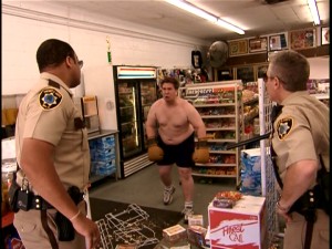 As on "COPS", Reno citizen spectacle supplies entertainment value. Like this crazy shirtless man (Nate Torrence) who vows to hold up a convenience store with his boxing gloved hands he dubs "fist bombs."