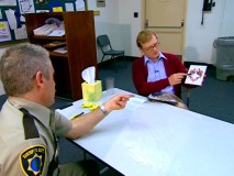 Deputy Garcia explains his assessment of an inkblot to state psychologist (Andrew Daly) in the Cop Psychology bonus feature.