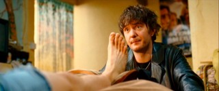 Dennis' best friend Gordon (Dylan Moran) is there for advice and support, like treating a giant foot blister.