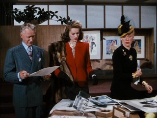 John Coudair (Otto Kruger), Cornelia "Stonewall" Jackson (Eve Arden), and real-life cover girl Jinx Falkenburg sort through various headshots in "Cover Girl."