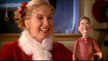 Serving as Elfonometry teacher to elves much older than her, Carol laughs at a little wooden Tim Allen doll while fielding questions from Abigail Breslin in this Alternate Opening.