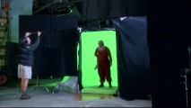 Santa stands in front of a green screen for a fireplace effects shot, as seen in "Creating Movie Magic."