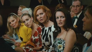 Samantha (Kim Cattrall), Carrie (Sarah Jessica Parker), Miranda (Cynthia Nixon), and Charlotte (Kristin Davis) are none too pleased when someone tries outbidding them at an auction.