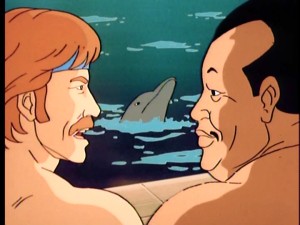 Chuck Norris and his equally shirtless friend, Blasian samurai Tabe, speak in profile, while a dolphin swims between them in "Deadly Dolphin."