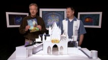 Imagineering VP Tony Baxter shows off his attraction souvenir book while Chris Merritt looks on in their introductory Guided Tour video.