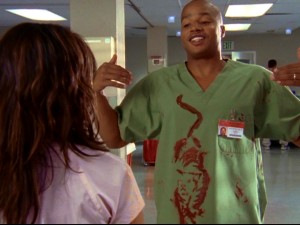 Turk shows Carla his surgical blood splatter resembling a tiger. (He used ketchup on the tail.)