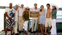 Eight "Scrubs" cast members pose happily by a Hope Town welcome sign in "My Bahamas Vacation."