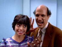 Ted (Sam Lloyd) and his girlfriend Gooch (Kate Micucci) make the best of a stuck elevator situation by singing a song for every American state.