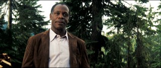 Colonel Isaac Johnson (Danny Glover) has a slight lisp and a deceptive warmth.
