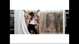 Shontelle claims a dressing room next to a large, projected Isla Fisher in the "Stuck with Each Other" music video that features three sets of bars on a 4x3 TV.