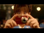 A Japanese waitress is either seeing something supernatural or has never experienced modern technology  before in this extended scene.
