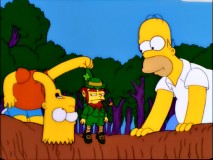 Homer and a long-necked Bart find the leprechaun they hope will clear the family curse in "Treehouse of Horror XII."